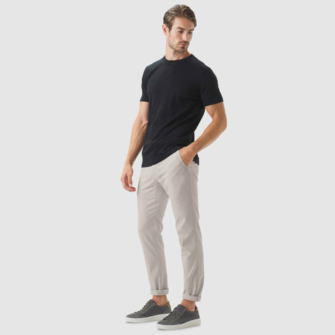 Jetsetter Tech Pant Slim Fit in microbeige, worn by a model, showcasing versatile and travel-friendly design.