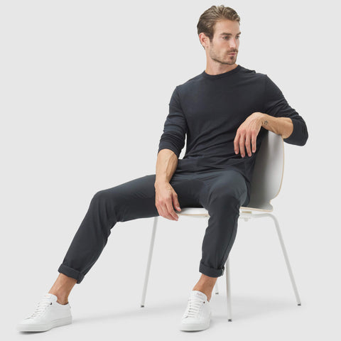 Jetsetter Tech Pant Slim Fit worn by model sitting on a chair.