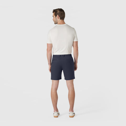 Man wearing Jetsetter Tech Short in navy, standing from the back.