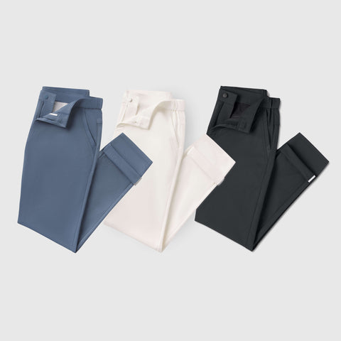 Jetsetter Tech Pant Slim Fit 3-Pack in blue, white, and black, showcasing wrinkle-free and travel-friendly microfiber fabric.