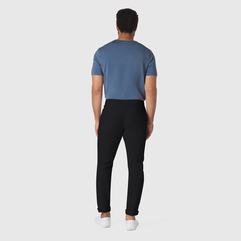 Slim fit Jetsetter Tech Pant in black, travel-friendly and wrinkle-free, featuring anti-odor and stain-repellent technology.