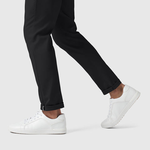 Slim fit Jetsetter Tech Pant shown in black fabric, paired with white sneakers, ideal for travel and comfort.