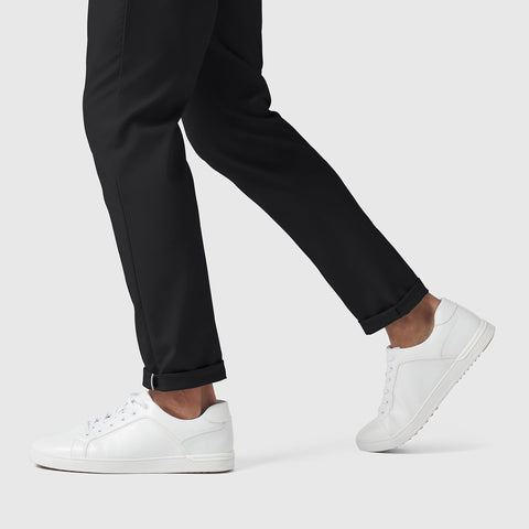 Slim Fit Jetsetter Tech Pant with white sneakers, featuring wrinkle-free microfiber fabric and rebound stretch.