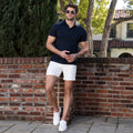 Man wearing Jetsetter Tech Short in a casual outdoor setting.