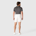 Man wearing Jetsetter Tech Short in white, showcasing a consistent fit and innovative fabric.