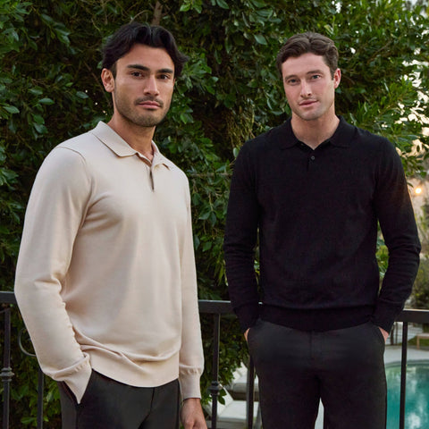 Men wearing Legacy Polo Sweater in cream and black standing outdoors.