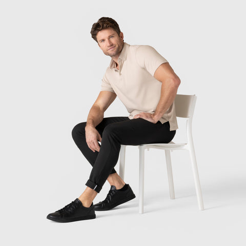 Man wearing Jetsetter Tech Pant Slim Fit sitting on chair