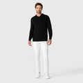 Legacy Polo Sweater in premium viscose blend, modeled with white pants and sneakers.