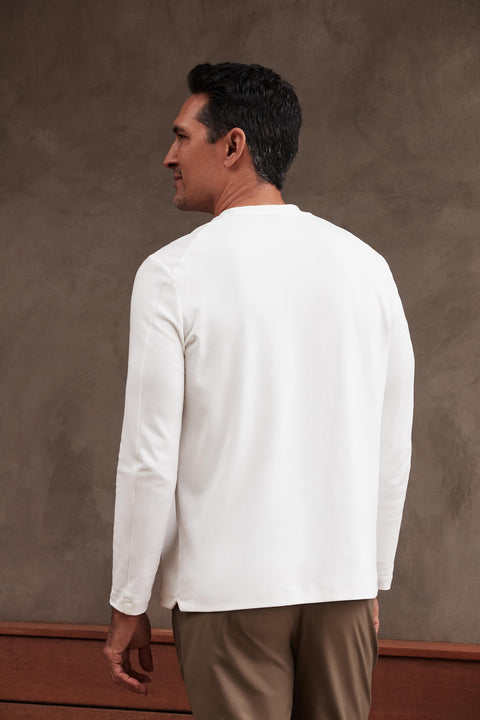 Precision Long Sleeve Tee in white organic cotton, shown from the back on a male model.