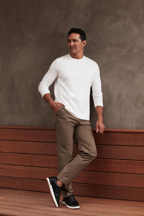 White Precision Long Sleeve Tee made from organic cotton, emphasizing shoulders, worn by a man.